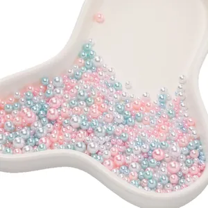 Mixed size ABS no-hole faux pearls in pink, blue, and white for DIY jewelry crafts.
