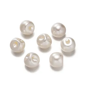 Detailed macro view of round white ABS faux pearl shank buttons for women's shirt
