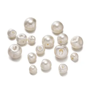 Detail of cream ABS imitation pearl buttons with side holes for elegant garment sewing