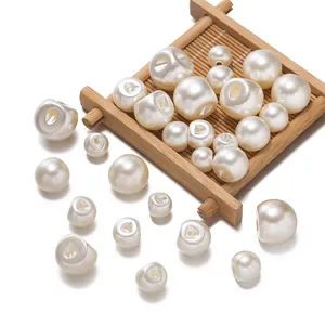 Macro view of assorted sizes white round ABS faux pearl shank buttons for women's shirt