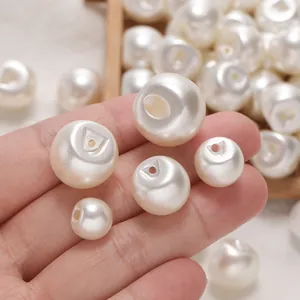 Macro view showing various sizes of ABS imitation pearl buttons with practical side holes