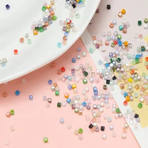 Vista dettagliata di perline in vetro a cubo color macaron per creazioni di gioielli fai-da-te.