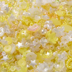 Mixed yellow acrylic flower and star beads for DIY jewelry and nail art accessories.