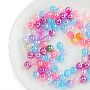 Colorful AB iridescent candy beads for DIY jewelry and phone chain making on white plate.