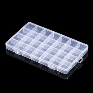 Detailed macro view of a 28-compartment clear plastic organizer box for jewelry storage
