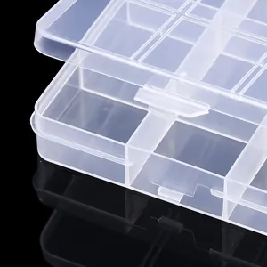Close-up of clear plastic storage box latch and multi-grid compartments for jewelry