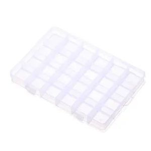 High angle detail of 24-grid transparent plastic storage box for jewelry sorting and crafts