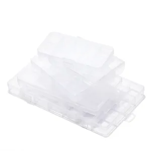 Set of stacked transparent plastic storage boxes with multiple compartments