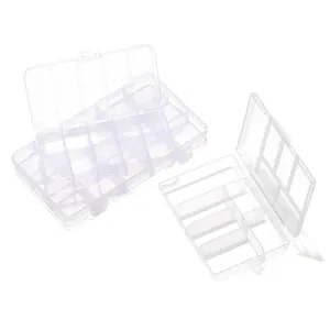 Detailed view of various clear plastic grid storage boxes for jewelry organization