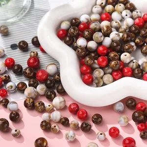 Macro detail of mixed red and marbled brown acrylic round beads for DIY jewelry