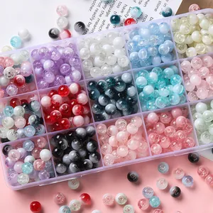 Detailed view of colorful crackle glass beads in a storage box for DIY jewelry making