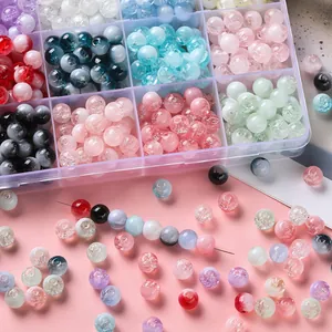 Close-up view of colorful cracked glass beads and organizer box for DIY jewelry making
