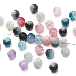 Detailed view of mixed colorful glass beads with crackle and gradient textures for DIY jewelry