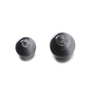 Macro view of two black and grey gradient glass beads for DIY jewelry making crafts