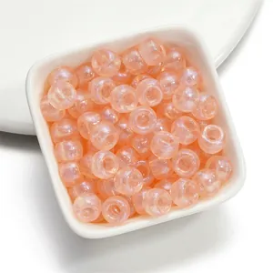 Peach mermaid finish acrylic barrel beads with large holes for DIY beading projects.