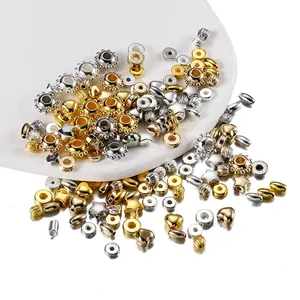 Macro view of gold and silver CCB beads in star, heart, and geometric shapes for DIY jewelry
