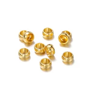Detailed macro view of golden stainless steel spacer beads for DIY jewelry making