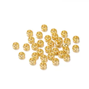 Detailed macro view of gold-plated stainless steel positioning beads for DIY jewelry