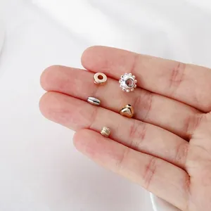 Macro detail of various gold and silver CCB jewelry beads in heart and star shapes