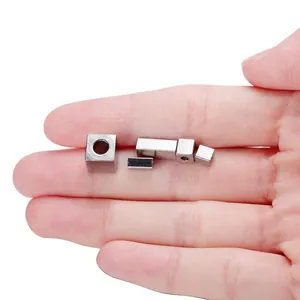 Macro view of multiple sizes of stainless steel square spacer beads for DIY jewelry