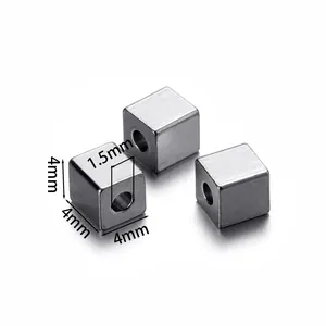 Detailed macro view of 4mm stainless steel cube spacer beads with a 1.5mm hole