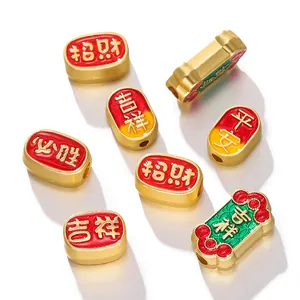 Macro view of Chinese-style gold spacer beads featuring embossed auspicious characters