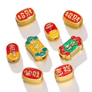 Detail shot of Chinese style matte gold enamel beads with auspicious Chinese characters