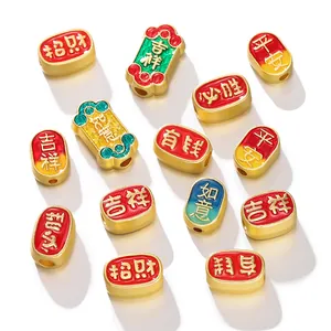Close-up of ancient gold style beads with Chinese blessing characters for DIY jewelry.