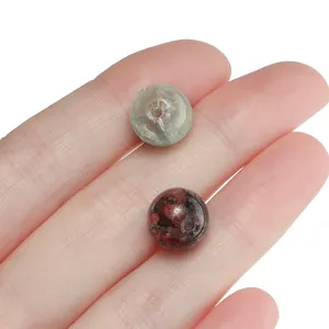 Detailed macro view of 10mm gold-flecked floral glass beads for DIY jewelry making accessories