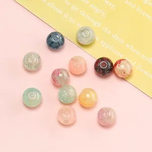Detailed view of 10mm glazed floral beads with intricate patterns for DIY jewelry