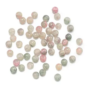 Detail showing 10mm gold-foiled marbled glass floral beads for DIY jewelry making.