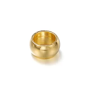 Close-up of a gold-plated stainless steel barrel positioning bead for DIY jewelry