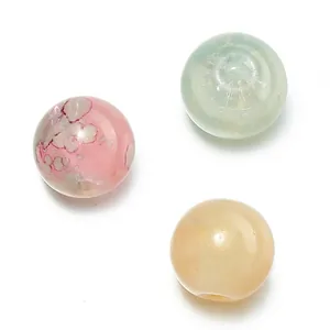 Detailed macro view of 10mm gold-gilded glazed glass beads for handmade DIY jewelry