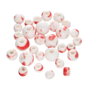Macro view of Jingdezhen ceramic beads with red splatter pattern for DIY jewelry