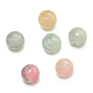 Macro view of 10mm gilded lampwork opal floral beads showing unique internal textures