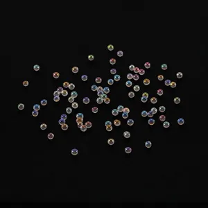 Iridescent bubble beads for DIY resin jewelry filler scattered on black background