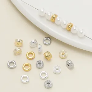 Detailed macro view of 18K gold and silver plated textured spacer beads for jewelry DIY
