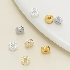 Detail view of textured 18k gold and silver plated donut spacer beads for DIY jewelry making