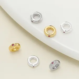 Detailed macro view of 18K gold plated jewelry spacer beads with pink stone inlay