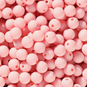 Close-up of matte pink acrylic round candy beads for handmade DIY jewelry crafting
