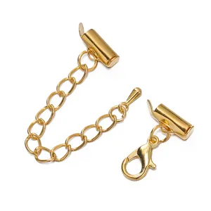 Detail of golden slide tube clasp set with extension chain and lobster clasp.