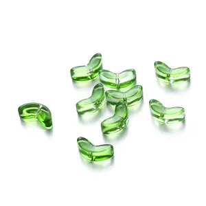 Macro detail of transparent green glass tulip petal beads for DIY jewelry making crafts.
