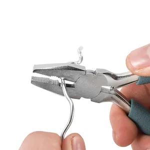 Macro view of 5-inch chrome vanadium steel pliers bending a silver metal craft wire