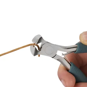 Macro detail of high-quality jewelry pliers cutting a gold snake chain for DIY