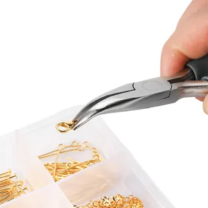 Detailed view of jewelry needle-nose pliers picking up a small gold lobster clasp.