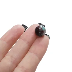 Macro detail of a 6-10mm ceramic bead with mottled turquoise and brown pattern for DIY