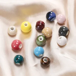 Detailed macro view of colorful assorted ceramic round beads on a silk fabric background.