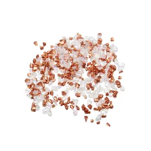 Close-up of irregular rose gold and iridescent glass stones for nail art and DIY crafts