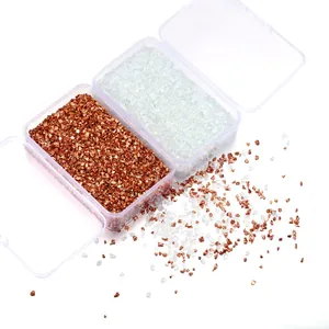 Detailed view of irregular rose gold and clear crushed glass stones in clear boxes