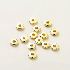 Close-up of golden plated brass wheel spacer beads for DIY jewelry making accessories